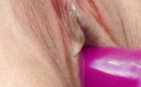 Toying her pussy upclose with a pink toy